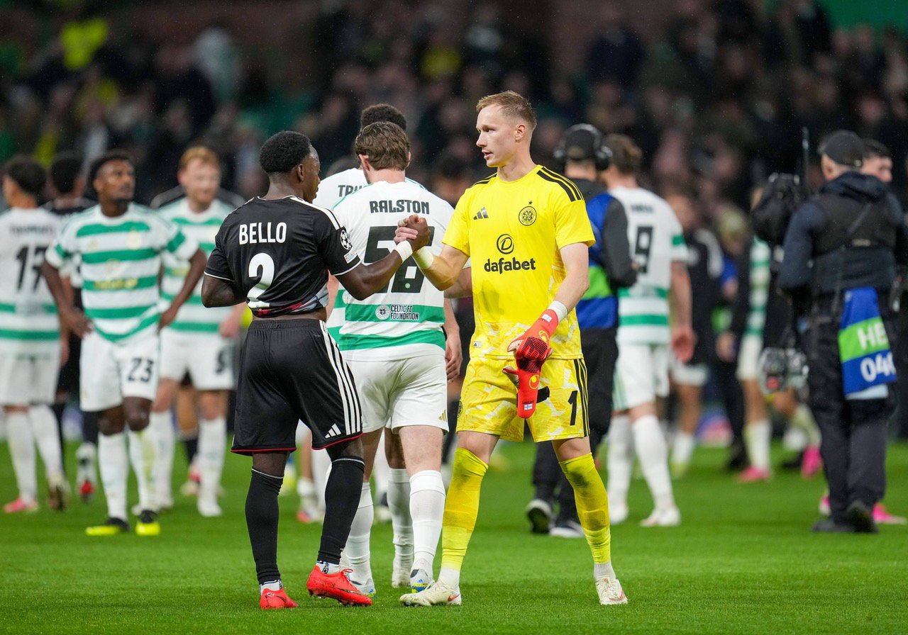 George Bello of LASK shakes hands with Celtic goalkeeper Viljami Sinisalo
