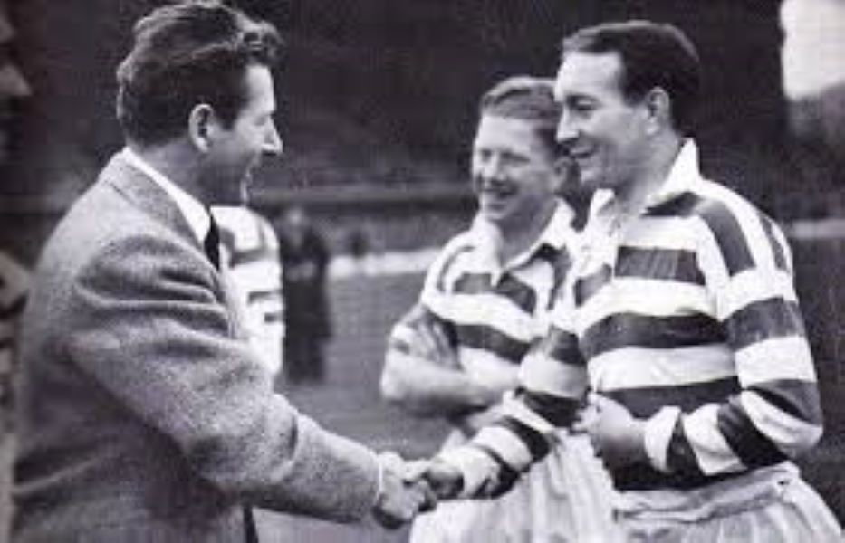 The Hollywood superstar Danny Kaye is introduced to Charlie Tully before the match as Bobby Evans looks on.