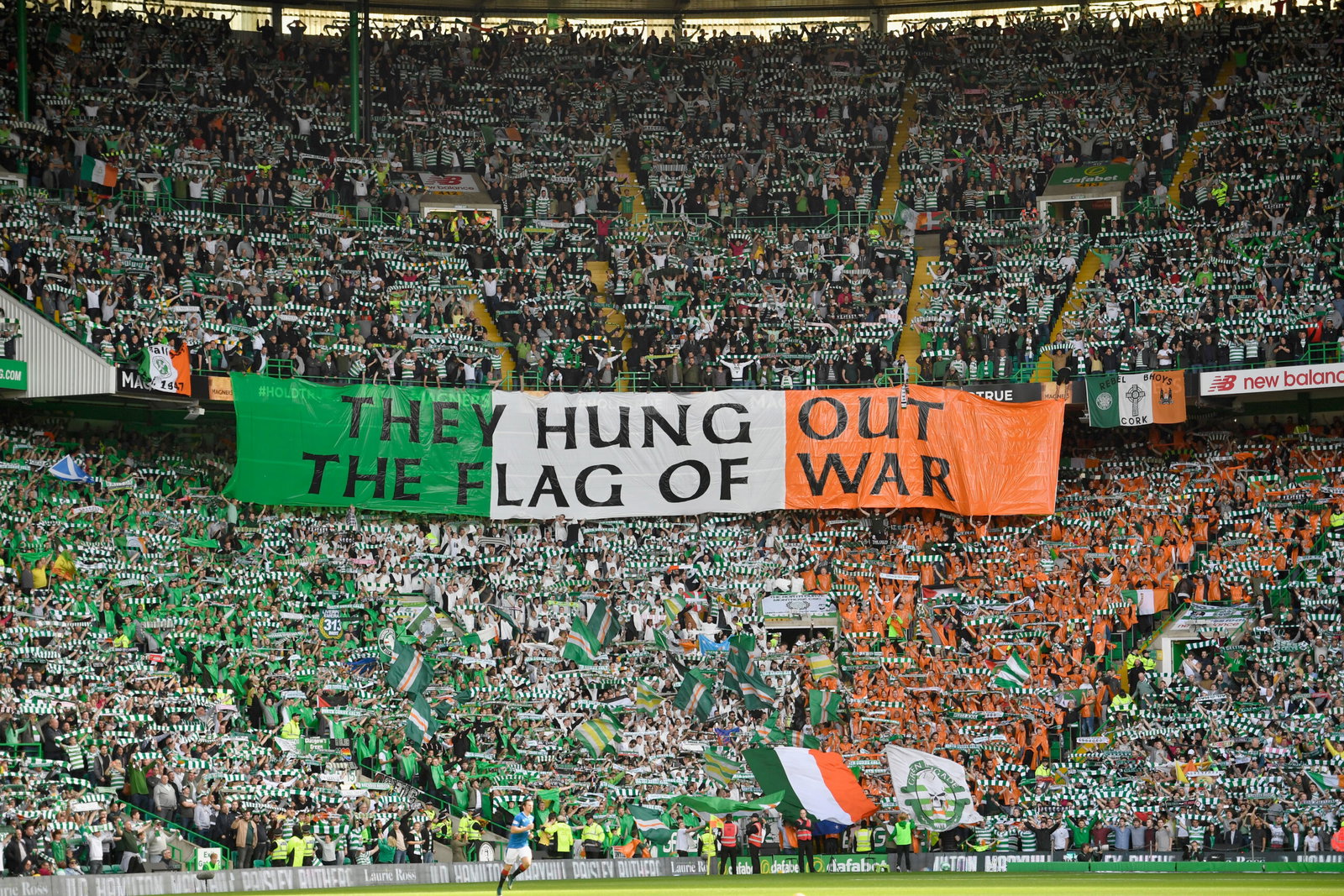 Celtic fans hold up a banner 