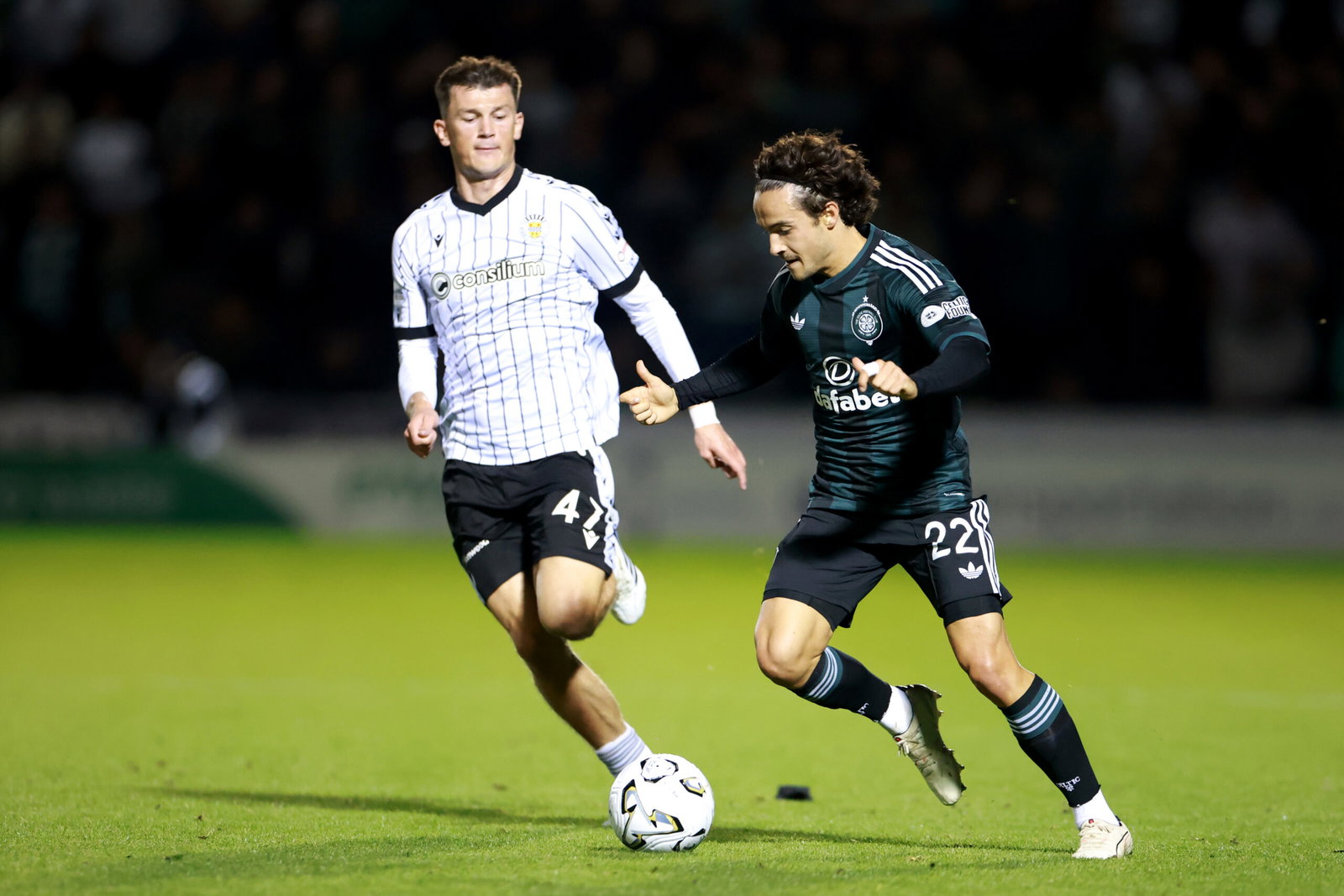 Mika Baur of Celtic runs with the ball