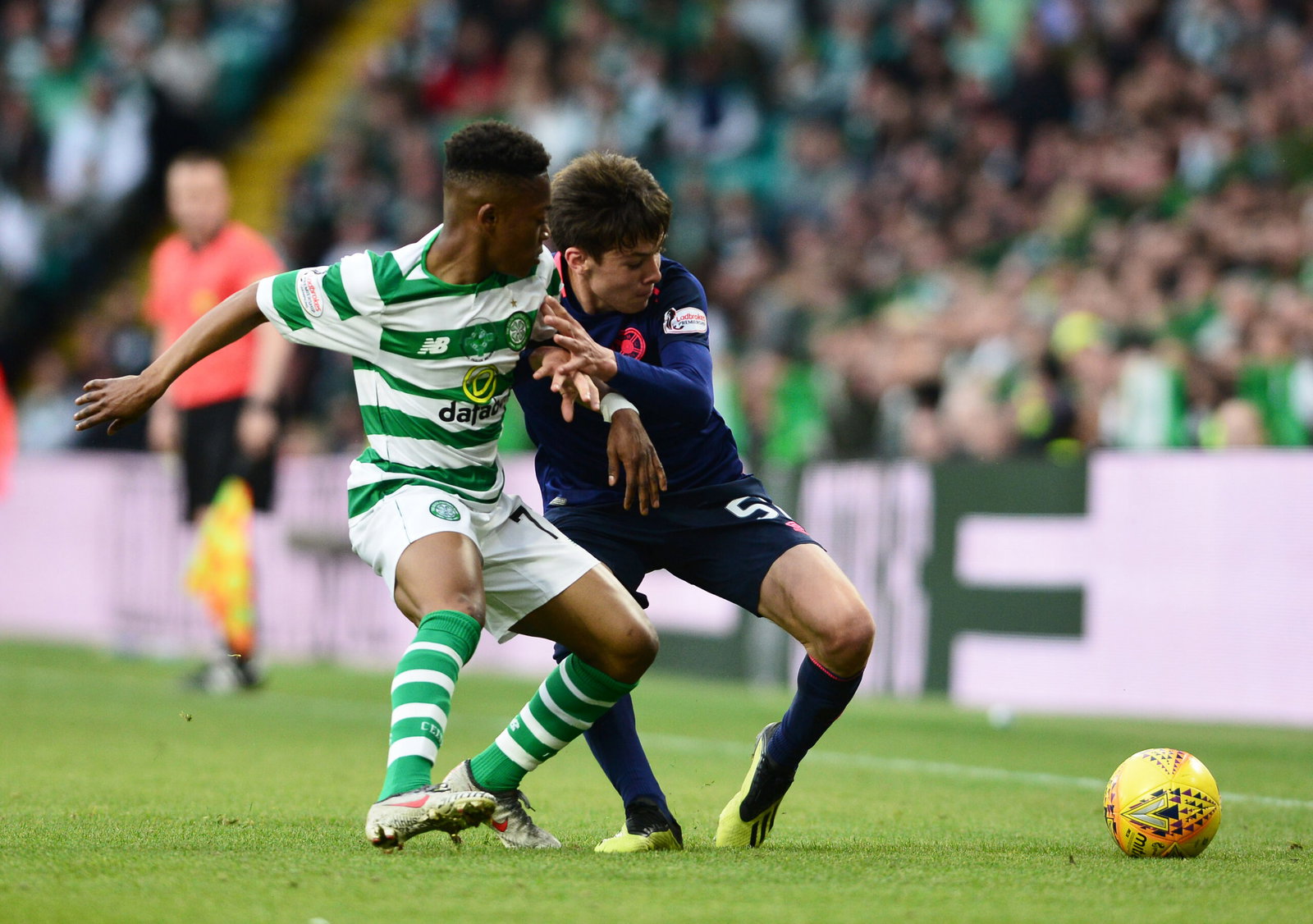 Aaron Hickey of Hearts holds off Karamoko Dembele of Celtic